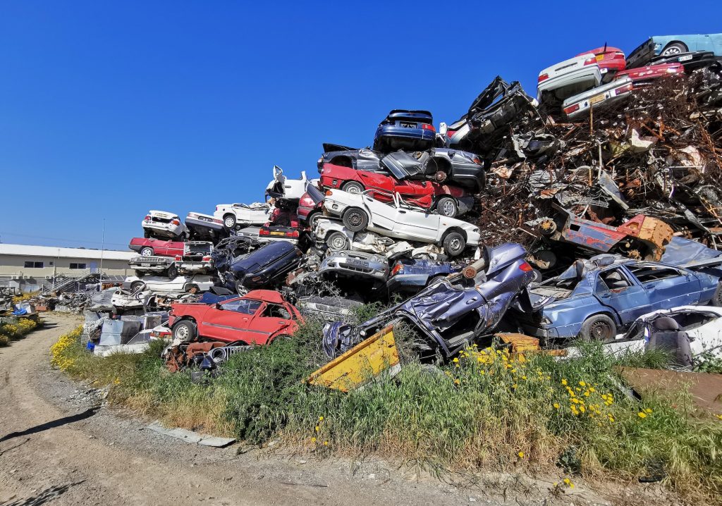 Pile of scrap cars and other metals on a junk yard ready recycling industry.